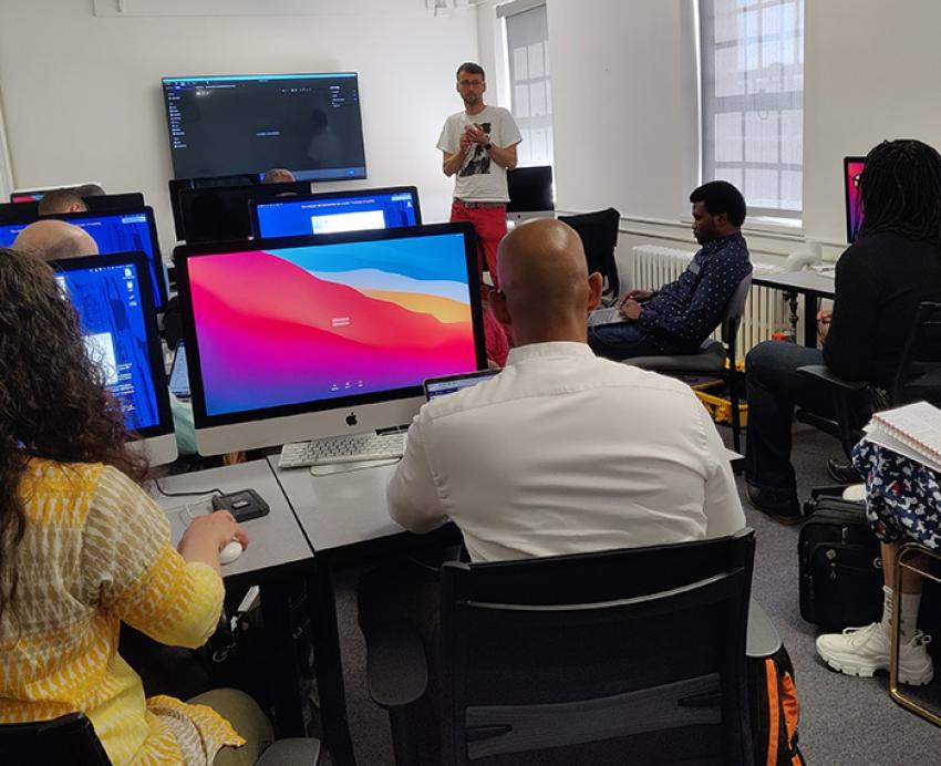 People sit in class in a computer lab