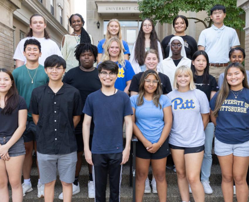 A group of students stand on stairs