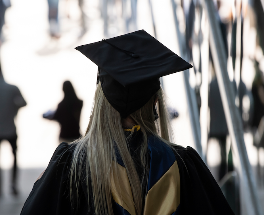 a person in a graduation cap from behind