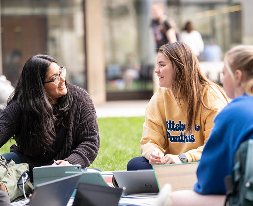 Students study on a lawn