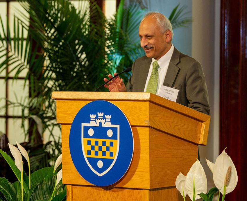 Shekhar at a podium with a Pitt shield logo