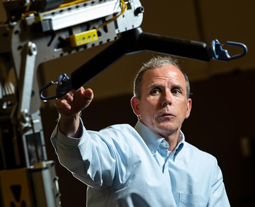 Cooper points to a part of an electric wheelchair