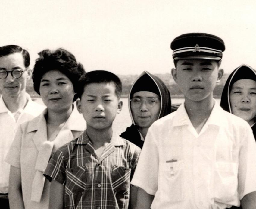 A black and white photo of a family