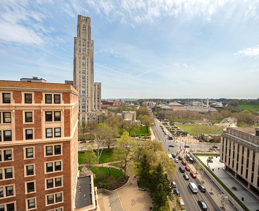 Cars stop at Forbes Avenue intersection near the Cathedral of Learning