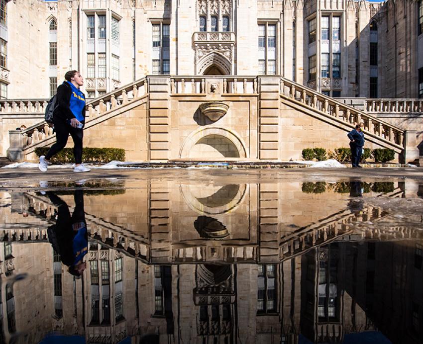 A person walks by the Cathedral of Learning.