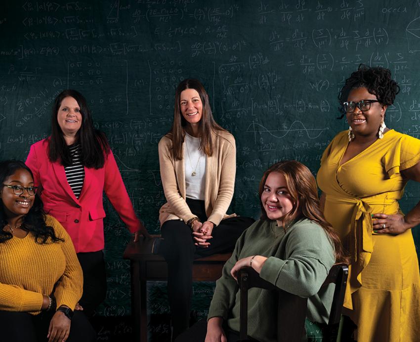 Five people in front of a chalkboard
