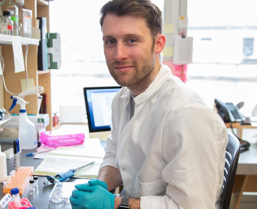 Anzell sits in a lab