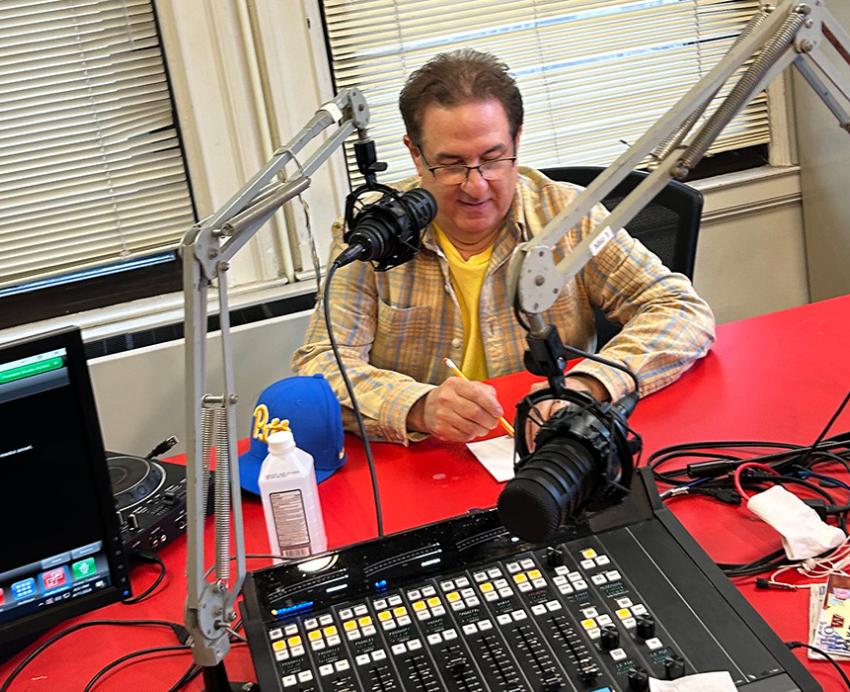 Bergman sits at a microphone in the WPTS studio