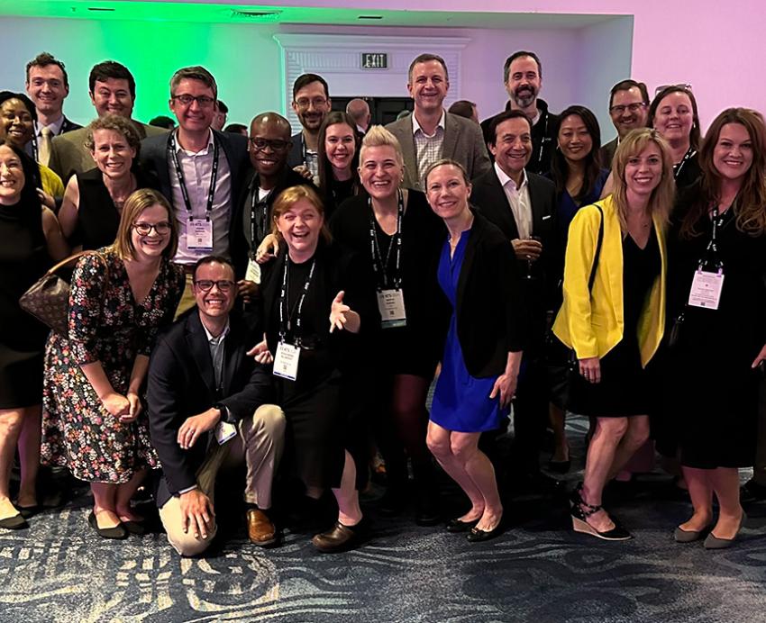 People pose at a conference