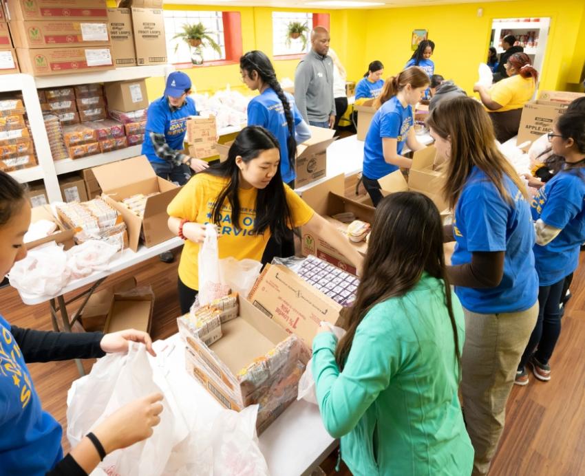 Pitt community members volunteer and bag items during MLK Day of service in the Hill District.