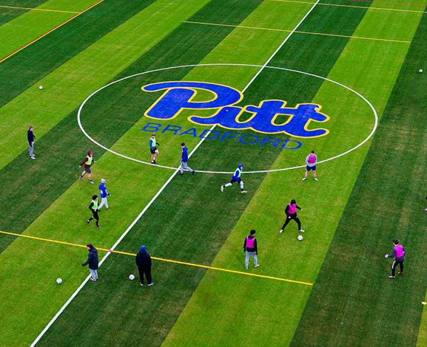 Soccer players on a Pitt-Bradford field