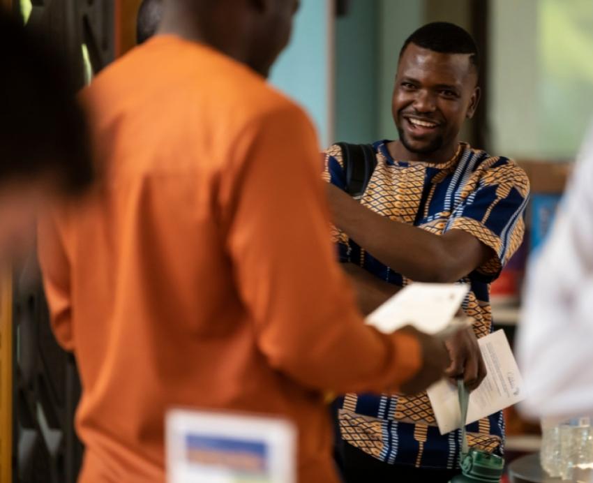 Students laugh and talk during a cultural event.