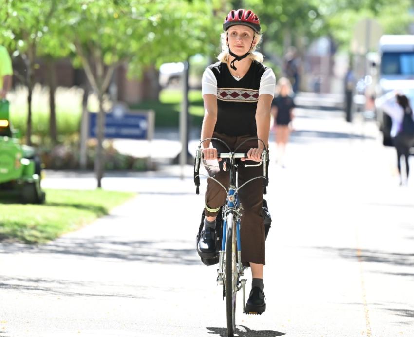 Pitt’s mobility specialist, Lucy Klug, rides her bike on campus.