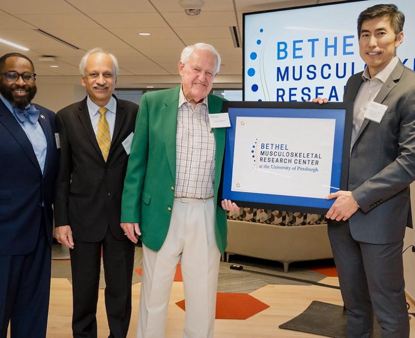 Hogan, Shekhar, Bethel and Lee hold up a framed research center logo