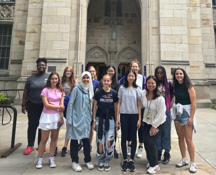 Math camp for girls attendees pose for a group photograph in front of the Cathedral of Learning.