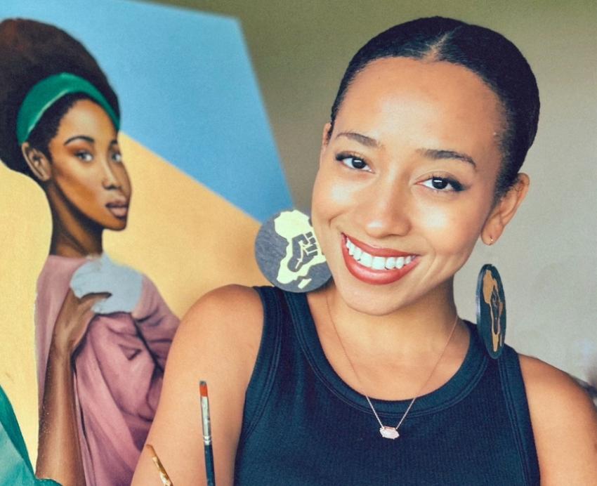Pittsburgh artist Morgan Overton smiles beside her "We Are Not Going Back" painting.