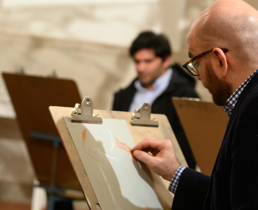 An individual draws during a University Art Gallery Maker Event.