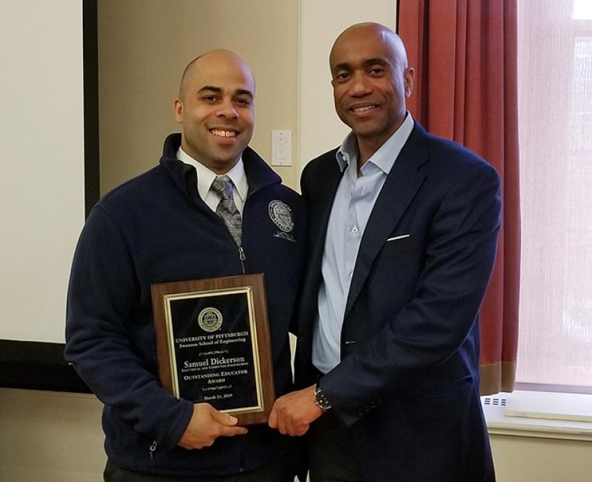 Dickerson holds his award with Dean James Martin