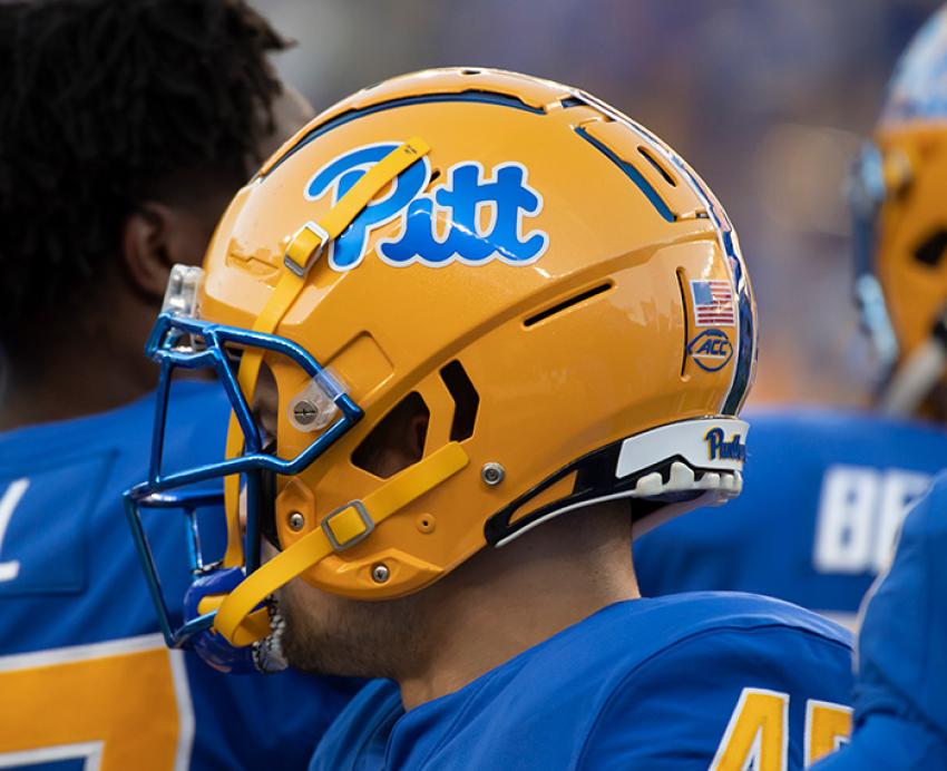 A football player in a yellow Pitt helmet