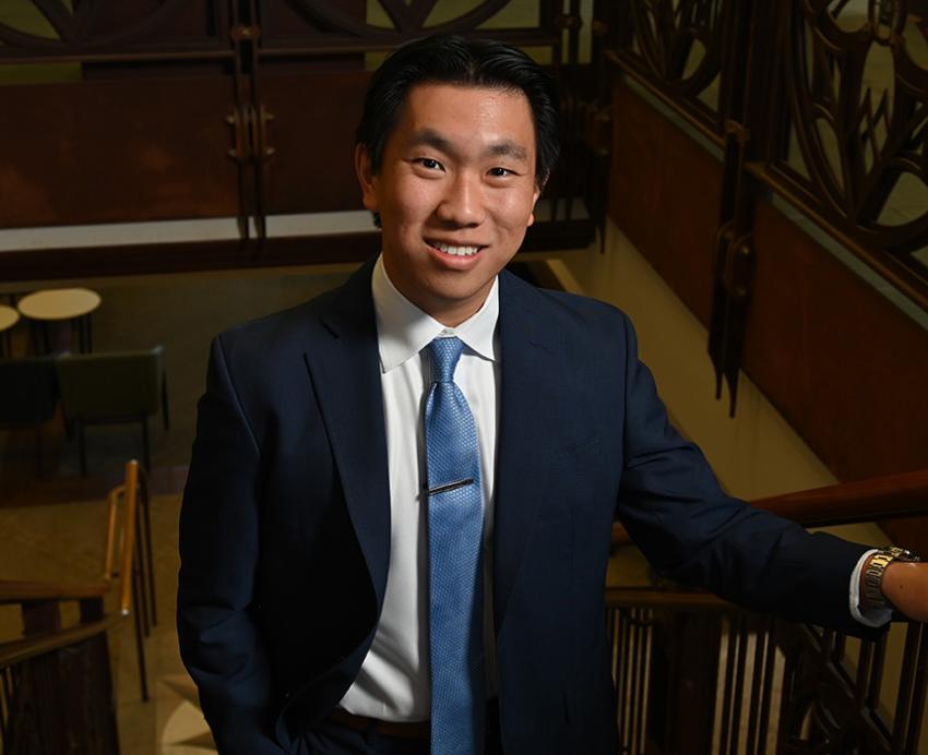 Fang on a staircase in the Honors College