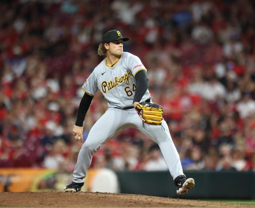 Baseball player throwing a pitch in a crowded stadium.