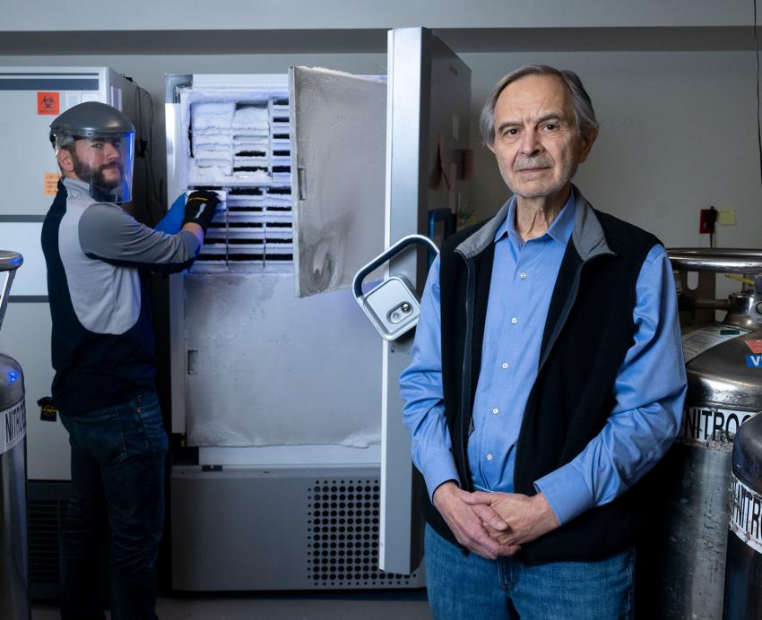 Charles Rinaldo poses for a portrait in the lab with a colleague.