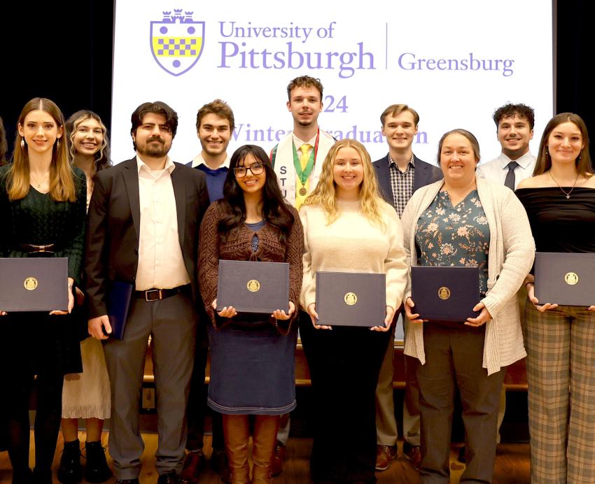 Pitt-Greensburg graduates pose for a portrait during the campus' first-ever winter commencement celebration. 