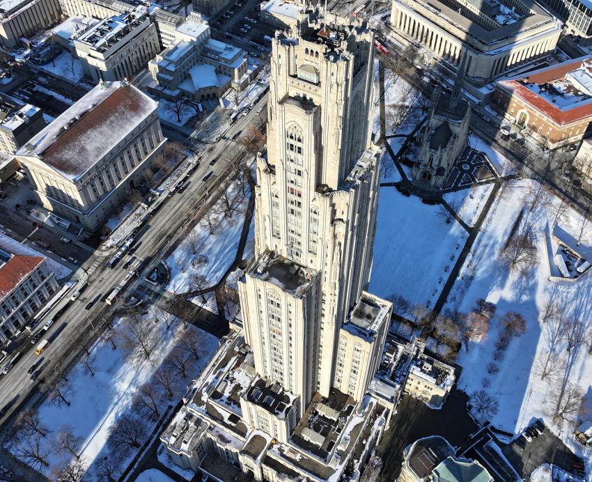An aerial view of the Cathedral of Learning during the winter.