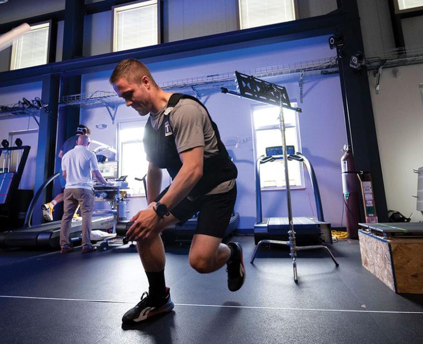 A person in athletic clothing exercising in a research lab