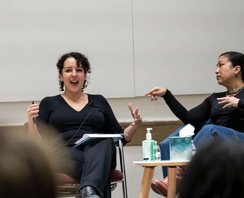 A fellow panelist points to Angie Cruz