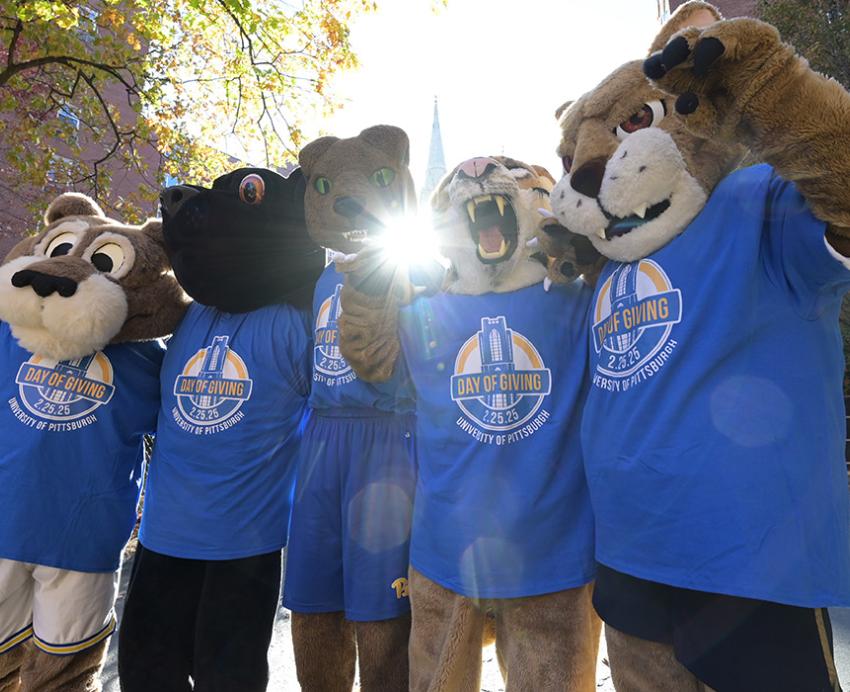 The five Pitt big cat mascots pose in Pitt Day of Giving shirts