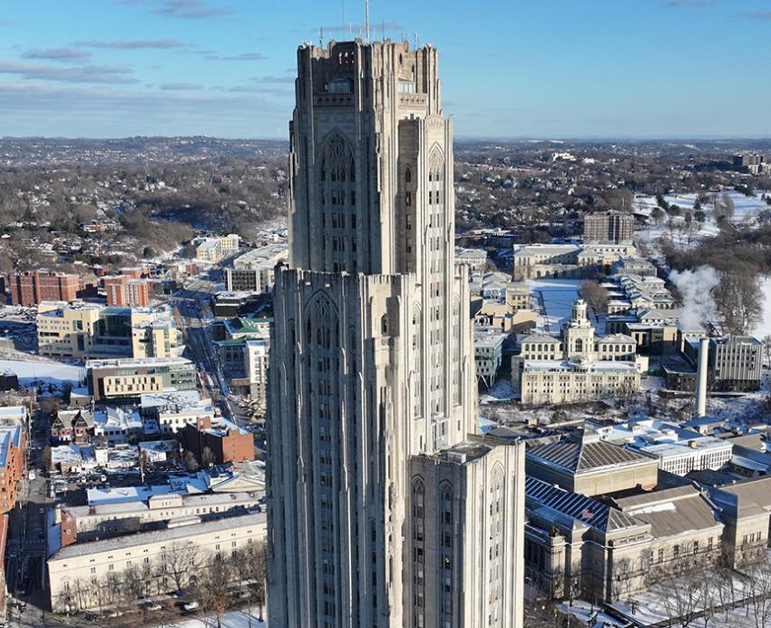 The Cathedral of Learning stands over the Oakland neighborhood on a snowy day