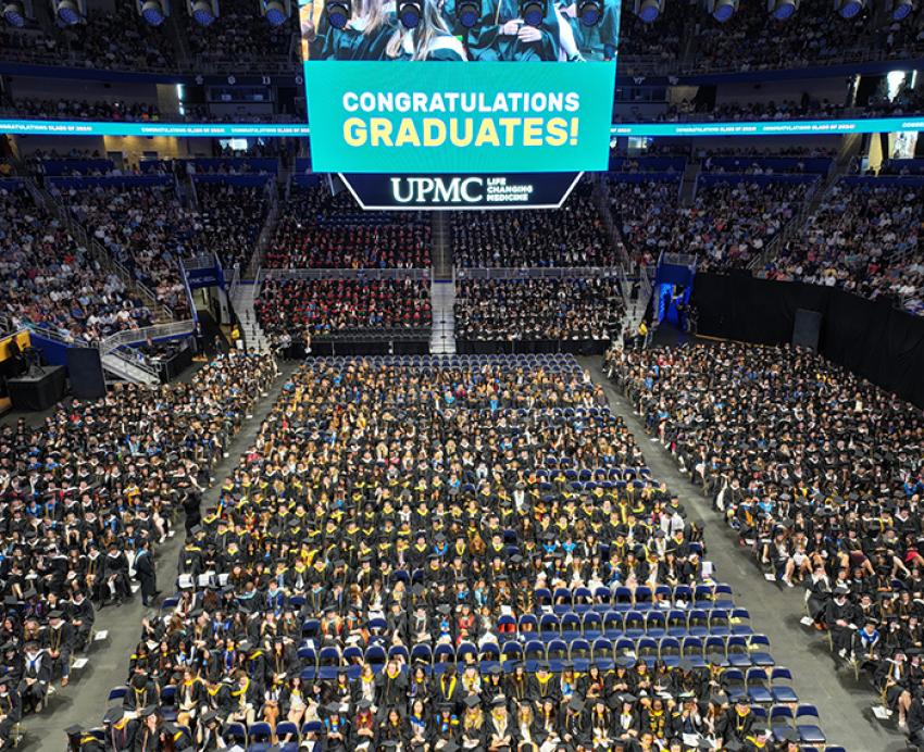 Crowd of seated students at Pitt commencement