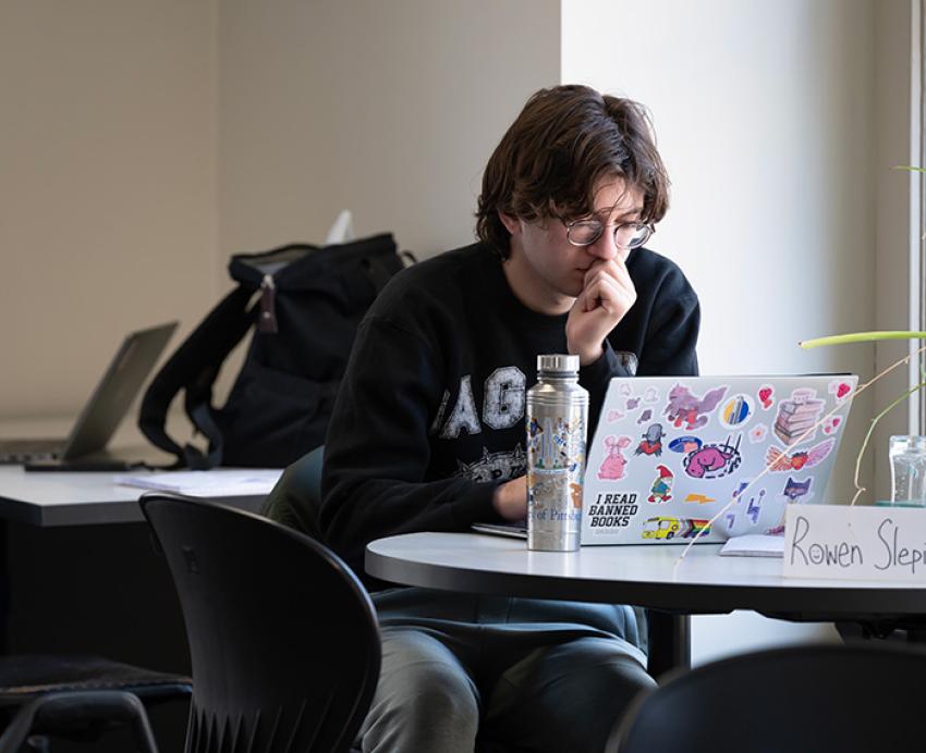 A student works on a laptop computer