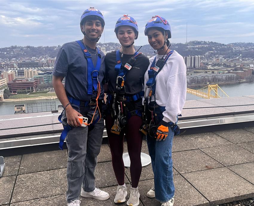 Students in helmets and gear on top of a roof in Pittsburgh