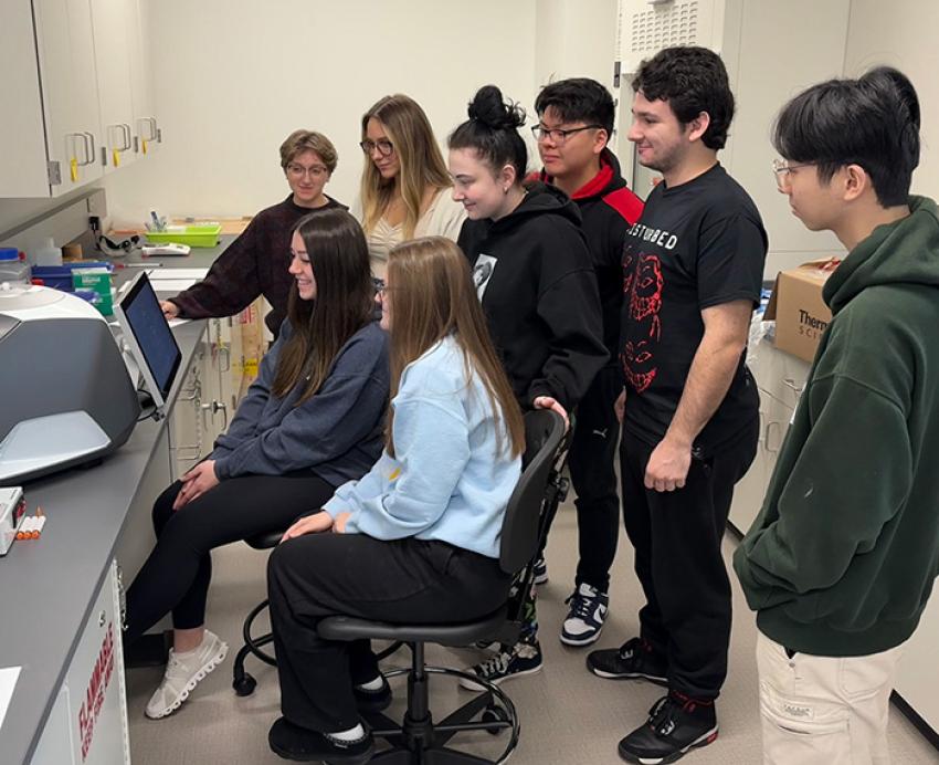 Students gathered around a screen