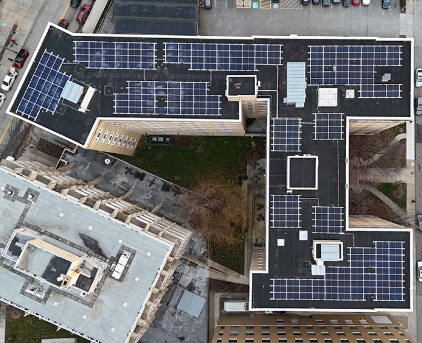 Many solar panels on a rooftop