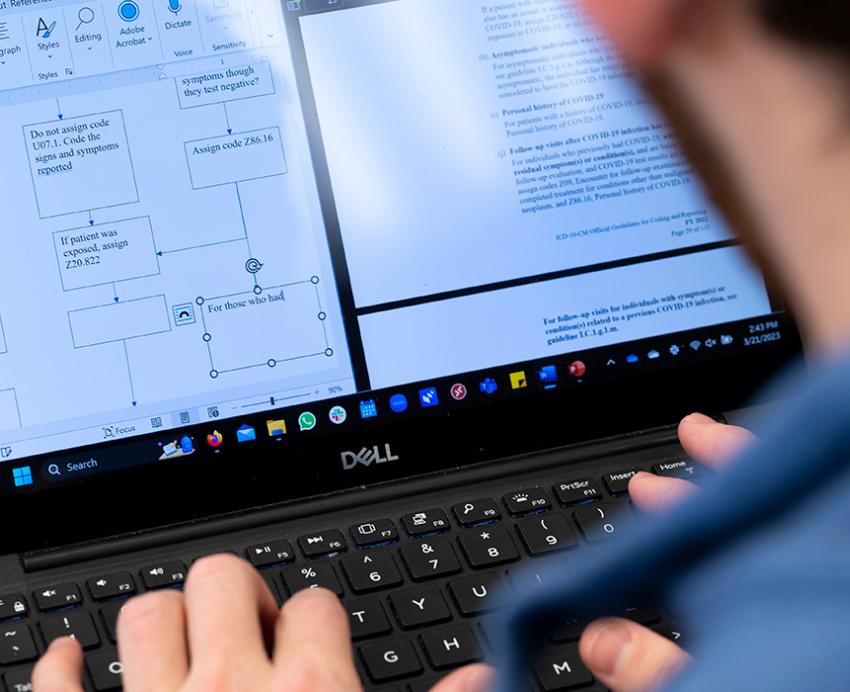 A student looks at documents on a computer screen.