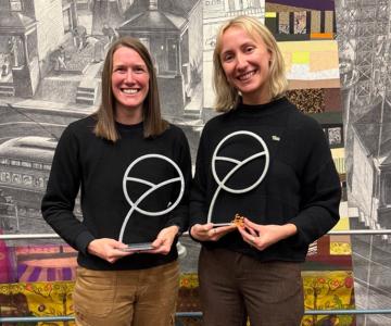 Sleva and Klug hold up their trophies