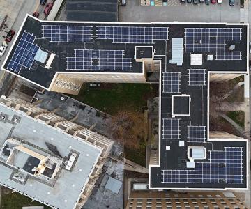 Many solar panels on a rooftop