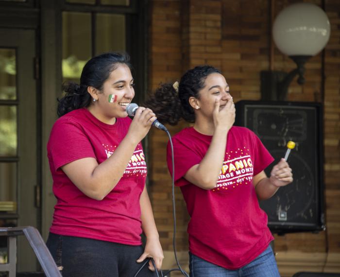 Two women in red "Hispanic Heritage Month" shirts