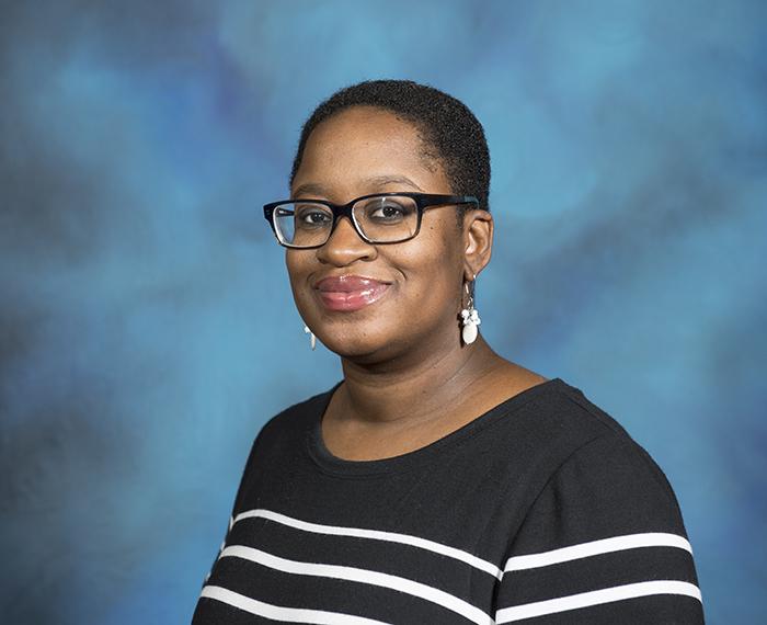 Keisha Blain wearing black sweater with white stripes