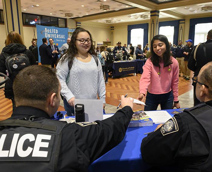 Police officers speaking with students at the Fall Safety Fair