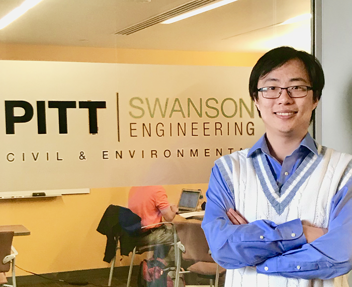 Yunxing Lu standing in front of Pitt Swanson Engineering sign