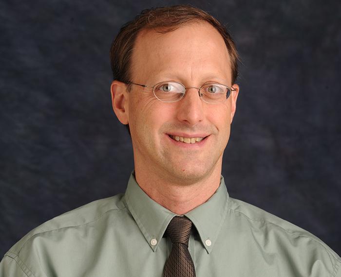 Todd Reeser wearing green shirt with black tie