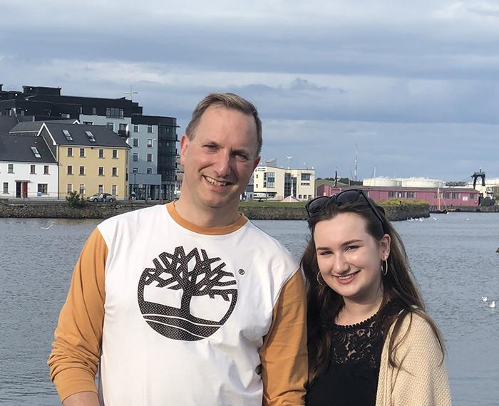 Riley Wolynn and her dad standing in front of river