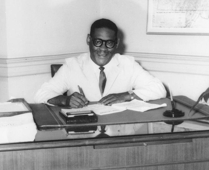 Irvis sitting at his desk