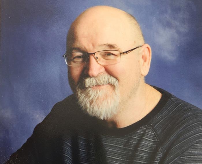 Dorsey Wheeler smiling in front of blue background