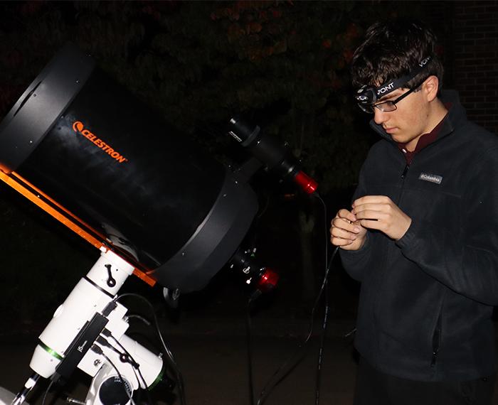 a person at a large telescope
