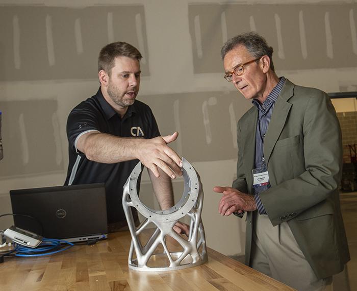 two people looking at a device on a table
